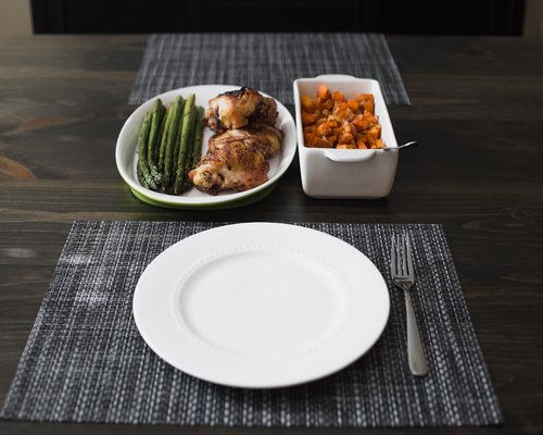 A table setting with a balanced meal including vegetables and beans