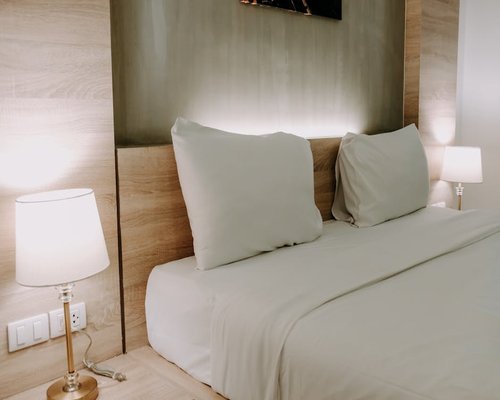 A comfortable bed with soft lighting